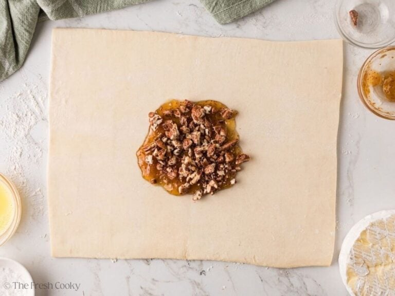 Chopped pecans sprinkled over fig jam on puff pastry.