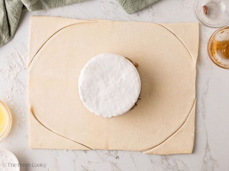 Puff pastry trimmed into a circle around the brie.