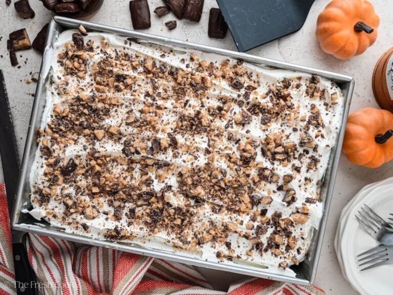 Overhead shot of a pumpkin poke cake in a baking dish.