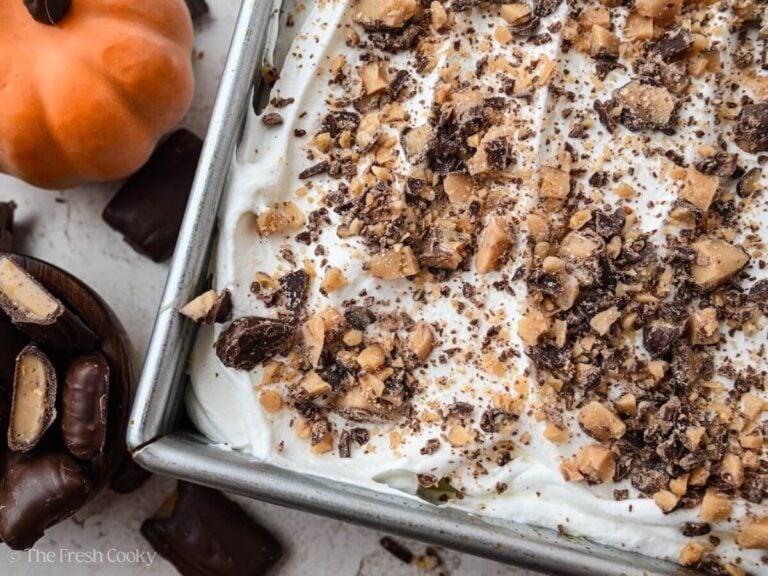 Close up of a corner of a pumpkin poke cake in a baking dish.