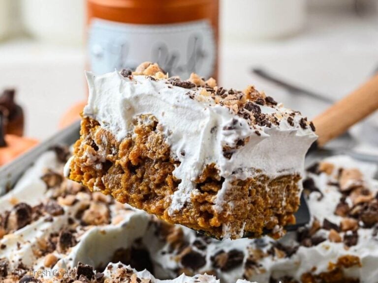 Spatula with a slice of pumpkin poke cake on it.