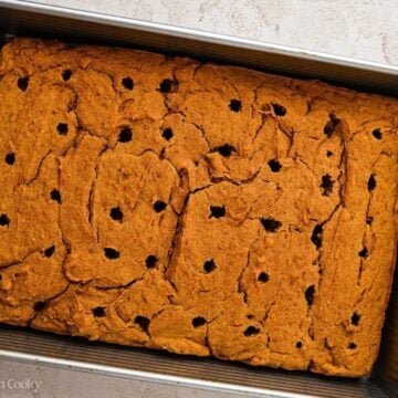 Holes poked into a baked pumpkin cake.