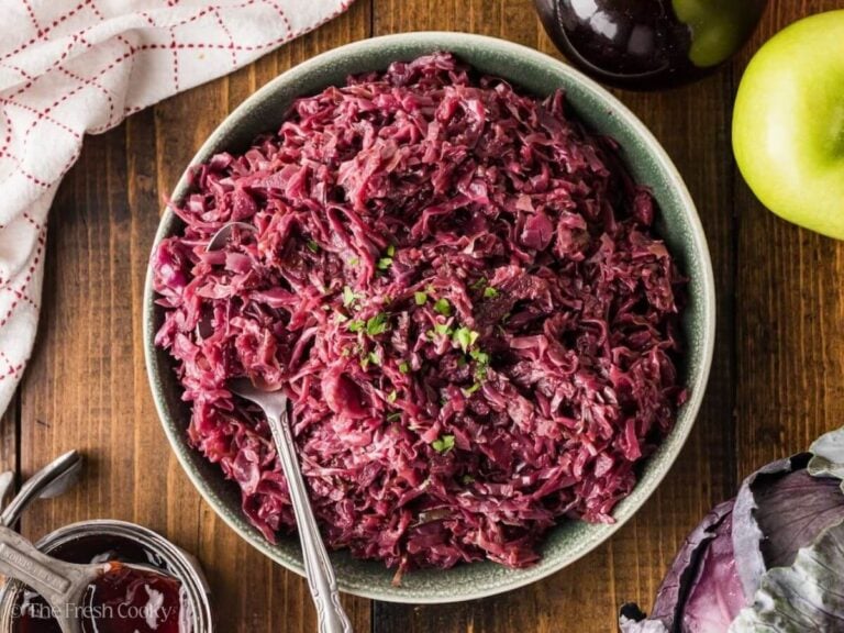 Serving bowl of rotkohl with a spoon in it.