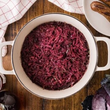 Braised red cabbage in a large white pot.