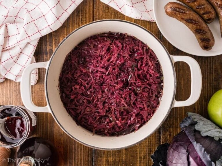 Braised red cabbage in a large white pot.