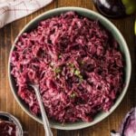 Large serving bowl of rotkohl with a spoon.