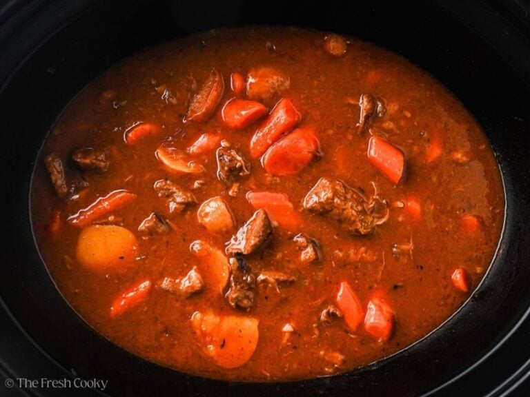Slow cooker beef stew in a black crockpot.