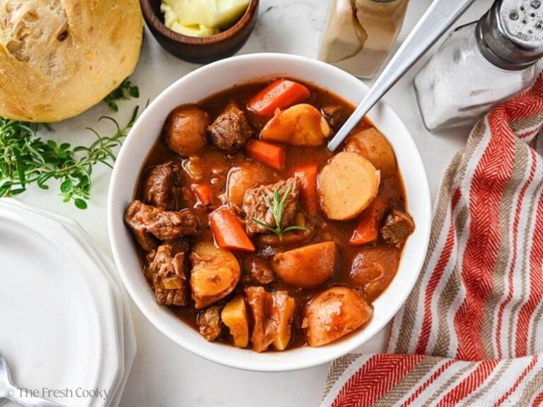 Overhead shot of a bowl of slow cooer beef stew in a bowl with a spoon.