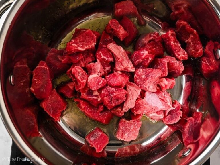 Beef stew meat placed in the pot to sear.