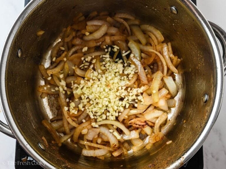 Onions and garlic added to the pot to sauté.