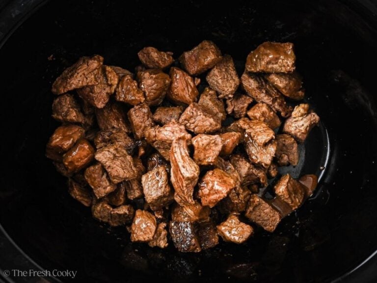 Seared beef added to the crockpot.