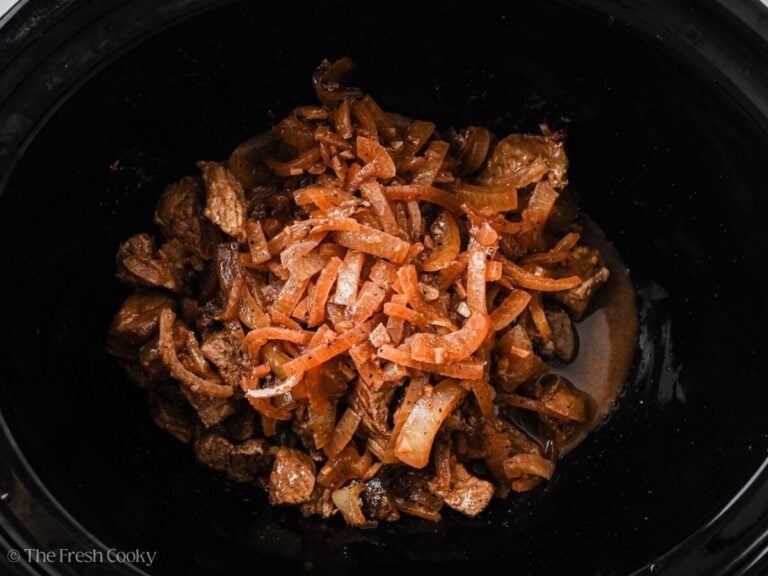Sauteed onions and garlic added to the slow cooker.
