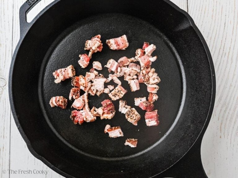 Bacon pieces in a pan ready to cook.