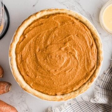 Baked sweet potato pie in a white baking dish.