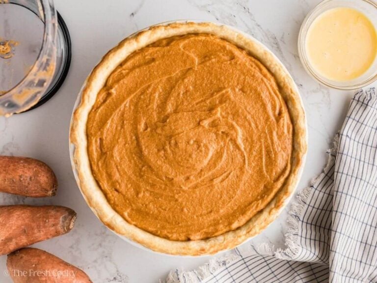 Baked sweet potato pie in a white baking dish.