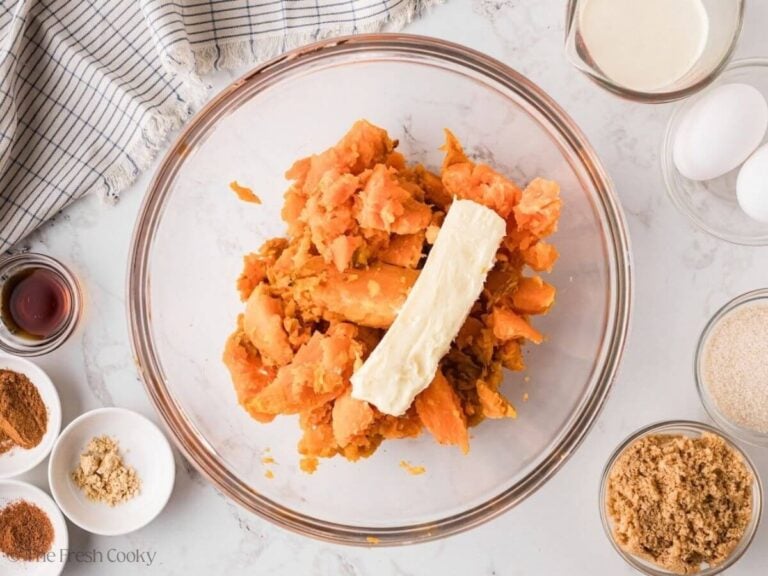 Sweet potatoes and a stick of butter in a mixing bowl.