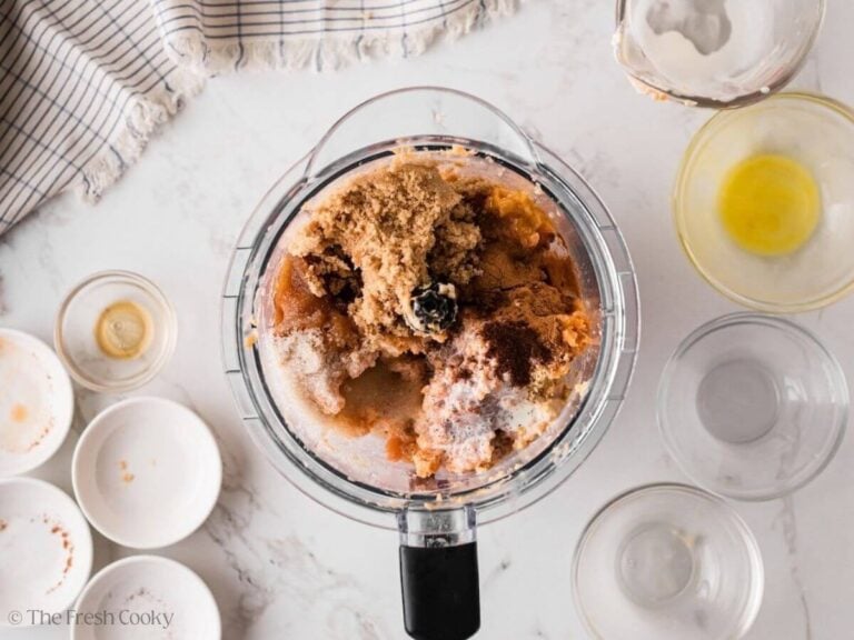 Sugar and spices added to the sweet potato mixture in a food processor.