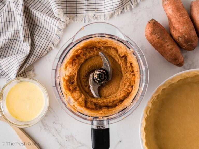 Creamy sweet potato mixture in a food processor after being blended.