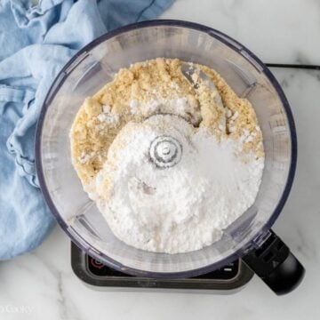 Almond flour and sugar in a food processor.