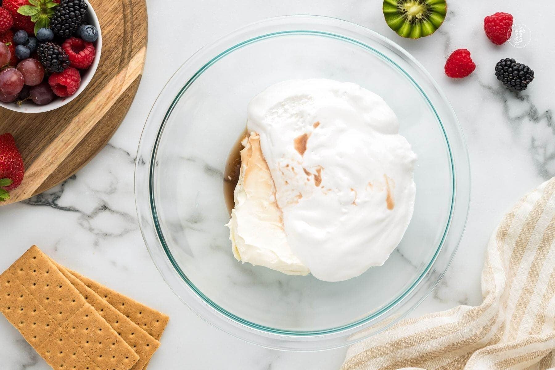 Marshmallow creme, cream cheese and vanilla in bowl.