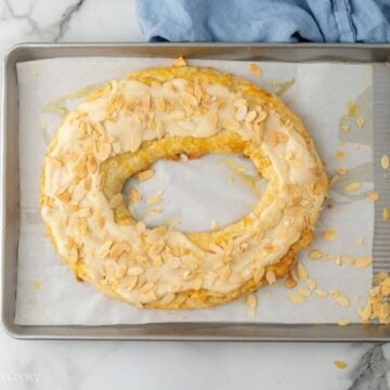 Almond kringle with glaze and sliced almonds on top.