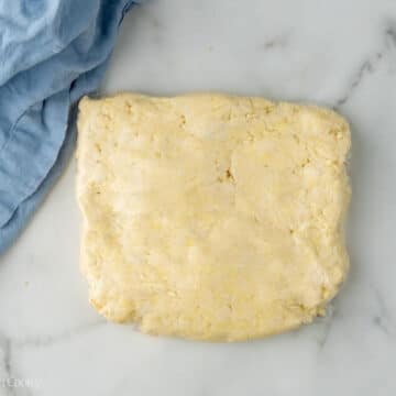 Almond kringle dough wrapped in plastic dough.