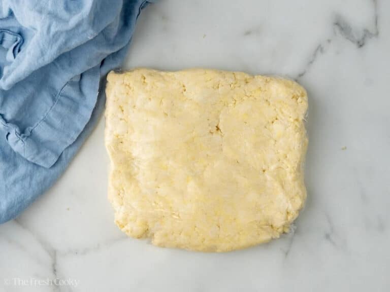 Almond kringle dough wrapped in plastic wrap.