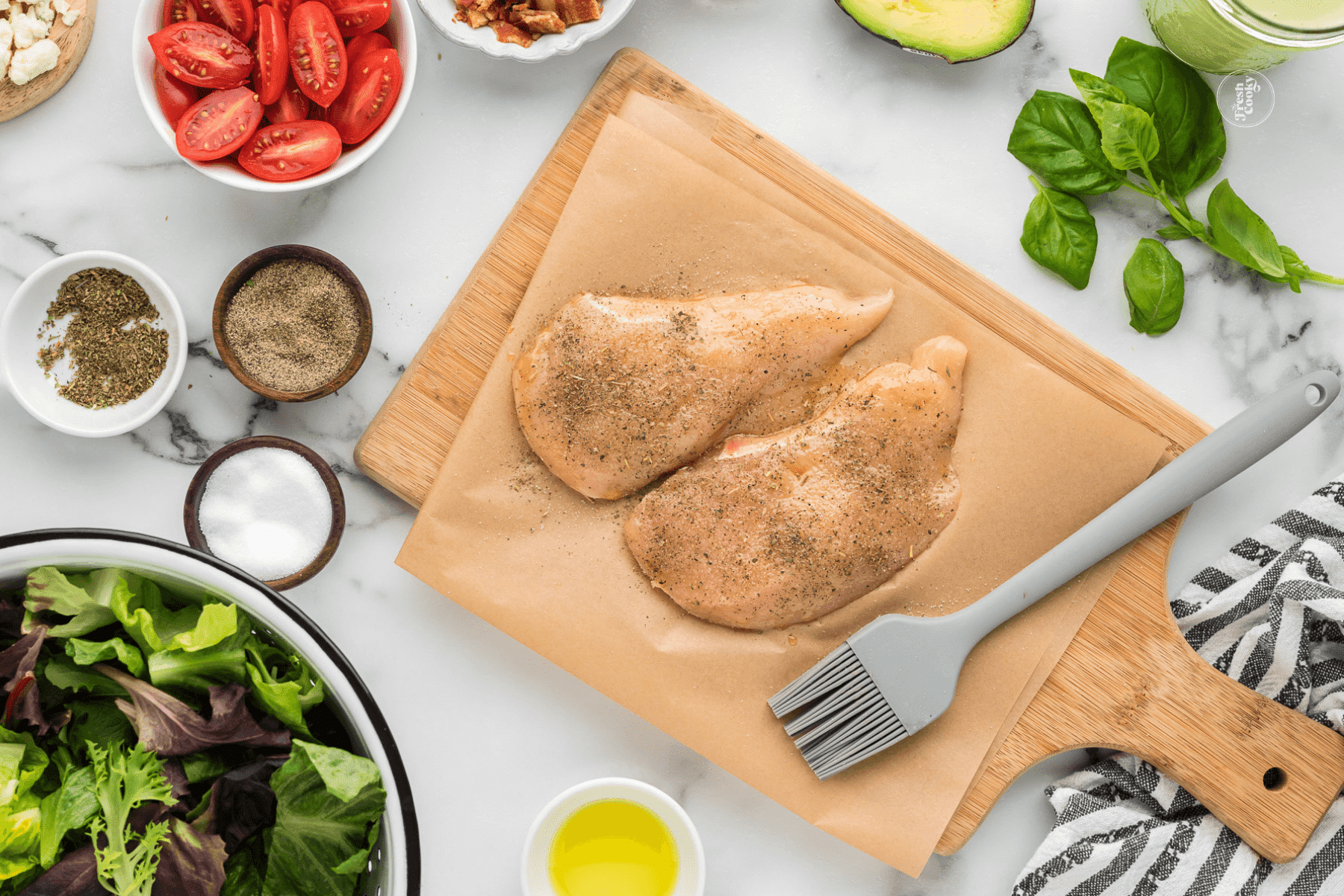 Chicken breasts rubbed with oil and seasoning.
