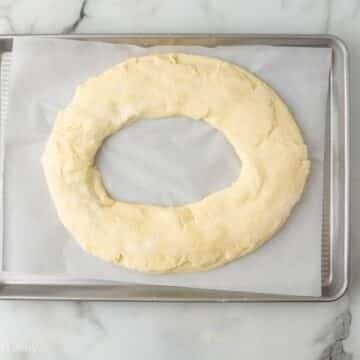 Kringle dough ring put together, on a parchment lined baking sheet.