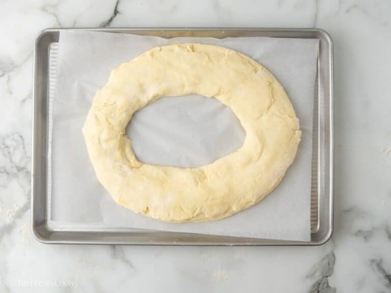 Kringle dough ring put together, on a parchment lined baking sheet.