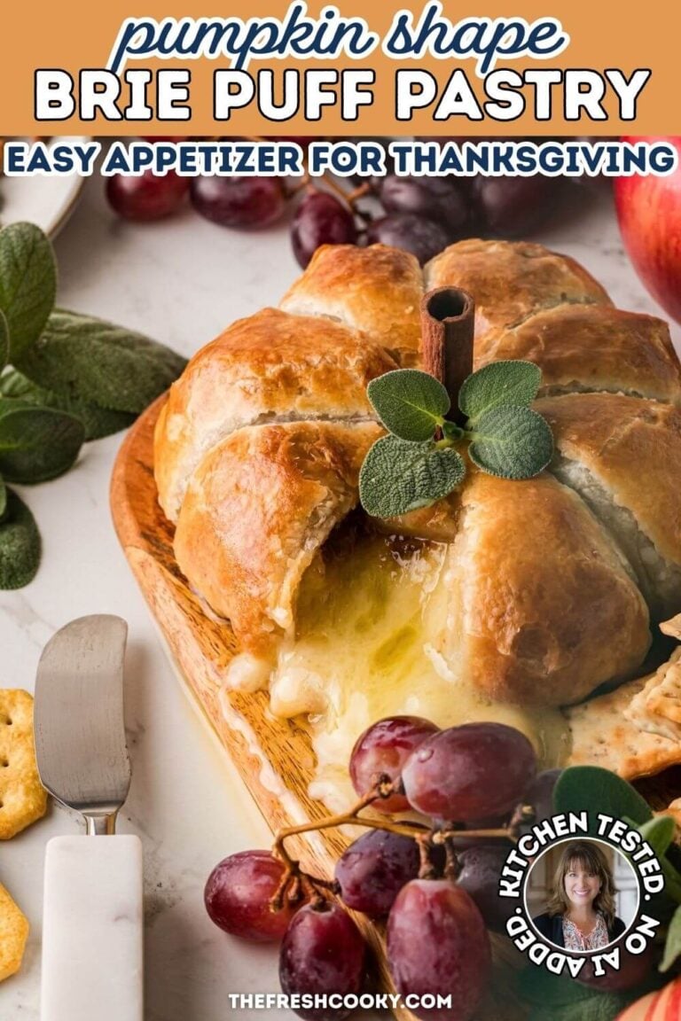 Cheese oozing out of a pumpkin shaped puff pastry baked brie - for pinning.
